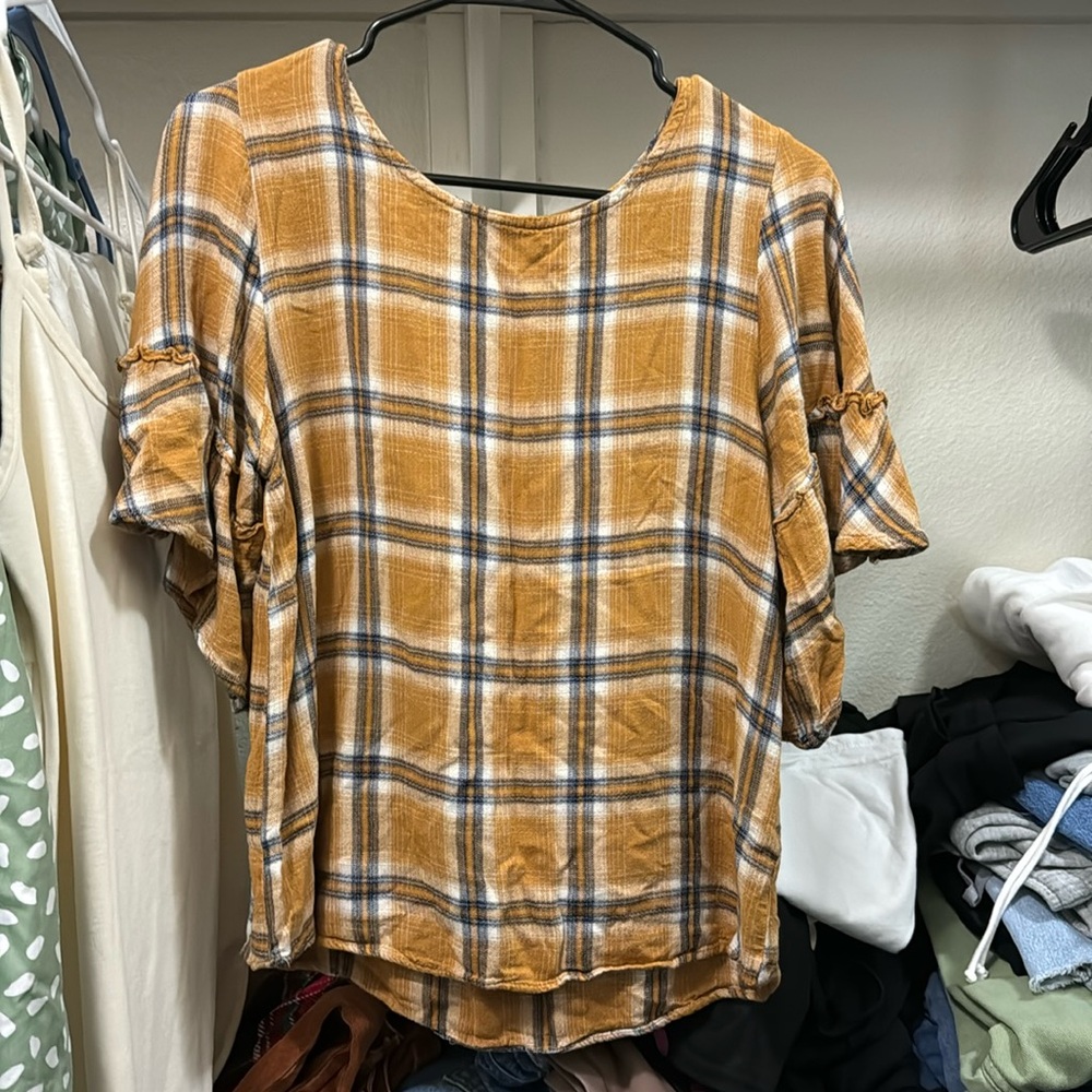 It’s Maurice’s shirt, plaid yellow color, size medium